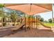Fun community playground with shaded play structures and slides in a lush outdoor area at 5840 E Holmes Ave, Mesa, AZ 85206