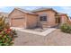 Inviting front exterior features a desert landscape, tile roof, and covered entryway for a welcoming feel at 684 E Redondo Dr, Gilbert, AZ 85296