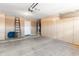 Spacious garage with ample storage cabinets, water heater, and epoxy flooring for durability at 684 E Redondo Dr, Gilbert, AZ 85296