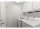Functional laundry room featuring a washer, a dryer, upper cabinets, and a utility sink at 684 E Redondo Dr, Gilbert, AZ 85296