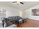 Spacious living room with ceramic tile floors, a ceiling fan, and abundant natural light from the front windows at 684 E Redondo Dr, Gilbert, AZ 85296