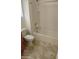 Bathroom features a tub, toilet, and tan tiled floor at 7325 W Wilshire Dr, Phoenix, AZ 85035