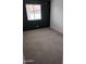 Cozy bedroom featuring a dark accent wall, carpet and natural light at 7325 W Wilshire Dr, Phoenix, AZ 85035