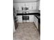 Modern kitchen with stainless steel appliances, ample counter space, and tile floor at 7325 W Wilshire Dr, Phoenix, AZ 85035