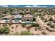 Aerial view features a home with a backyard pool in a neighborhood with desert landscaping at 7432 W Bronco Trl, Peoria, AZ 85383