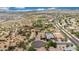 A high angle with houses nestled in a desert landscape, featuring roads and mountain views at 7432 W Bronco Trl, Peoria, AZ 85383