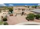 Expansive home with three-car garage, beautiful landscaping, and a paver driveway at 7432 W Bronco Trl, Peoria, AZ 85383
