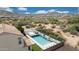 A high angle features a home with a backyard pool and desert landscape at 7432 W Bronco Trl, Peoria, AZ 85383