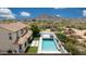 A high angle of the backyard, featuring a pool, lounging area and desert landscaping at 7432 W Bronco Trl, Peoria, AZ 85383