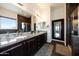 Bright bathroom features dual sinks with granite countertops, dark wood cabinets, and decorative tile at 7432 W Bronco Trl, Peoria, AZ 85383