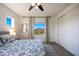 Bedroom with a ceiling fan, large windows with scenic views and carpet at 7432 W Bronco Trl, Peoria, AZ 85383