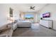 Bright bedroom with large windows, a king-size bed, and neutral décor, offering a peaceful retreat at 7432 W Bronco Trl, Peoria, AZ 85383