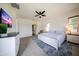 Cozy bedroom features a king bed, soft carpet, a ceiling fan, and ample natural light for a serene ambiance at 7432 W Bronco Trl, Peoria, AZ 85383