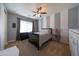 Comfortable bedroom with a ceiling fan, carpet, and decorative gray and white striped wall at 7432 W Bronco Trl, Peoria, AZ 85383
