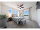 Inviting bedroom with natural light, plush carpet, and ceiling fan above bed with decorative pillows at 7432 W Bronco Trl, Peoria, AZ 85383