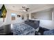 This bonus room offers large windows, a ceiling fan, carpet, and a mounted television at 7432 W Bronco Trl, Peoria, AZ 85383