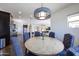 Comfortable dining room area featuring a wooden table and chair set illuminated by decorative lighting at 7432 W Bronco Trl, Peoria, AZ 85383
