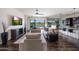 Open-concept living room featuring stylish decor and large windows that fill the space with natural light at 7432 W Bronco Trl, Peoria, AZ 85383