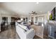 Bright living room offering an open layout to the kitchen and dining area with stylish neutral furniture at 7432 W Bronco Trl, Peoria, AZ 85383