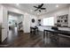 A spacious home office with hardwood floors, two desks, built-in shelving, and plenty of natural light at 7432 W Bronco Trl, Peoria, AZ 85383
