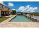 Sparkling pool with stone trim, poolside seating, and mountain views at 7432 W Bronco Trl, Peoria, AZ 85383