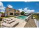 Expansive backyard featuring a refreshing pool, lounge seating, and lush artificial grass at 7432 W Bronco Trl, Peoria, AZ 85383