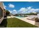 Inviting pool area with stone accents, lounge chairs, and mountain views at 7432 W Bronco Trl, Peoria, AZ 85383