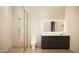 Clean bathroom with a glass shower, toilet and vanity with a framed, lighted mirror at 7445 E Vista Dr, Scottsdale, AZ 85250