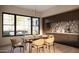 Bright dining room with a modern light fixture, stylish dining set, and view to outdoor patio at 7445 E Vista Dr, Scottsdale, AZ 85250