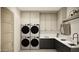 Functional laundry room with modern appliances, ample storage, and stylish countertops at 7445 E Vista Dr, Scottsdale, AZ 85250