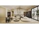 Stylish living room with a comfortable white sofa, modern lighting, and access to outdoor dining at 7445 E Vista Dr, Scottsdale, AZ 85250