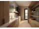 Walk-in pantry features custom shelves, ample storage, and easy access to the outdoor area at 7445 E Vista Dr, Scottsdale, AZ 85250
