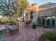 Relaxing backyard with a brick patio, outdoor grill, and lush greenery at 8022 N Ironwood Dr, Paradise Valley, AZ 85253