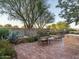 Charming backyard featuring a brick patio with outdoor seating and a decorative water feature at 8022 N Ironwood Dr, Paradise Valley, AZ 85253
