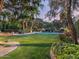 Expansive backyard with lush lawn, mature trees, and a sparkling pool, perfect for outdoor entertaining at 8022 N Ironwood Dr, Paradise Valley, AZ 85253