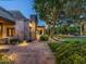 Picturesque backyard with a brick patio, lush landscaping, and a covered outdoor seating area at 8022 N Ironwood Dr, Paradise Valley, AZ 85253