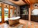 Elegant bathroom with a luxurious freestanding tub, access to the yard, and custom cabinetry at 8022 N Ironwood Dr, Paradise Valley, AZ 85253