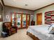 Bright bedroom with exposed brick and access to the outside through glass doors at 8022 N Ironwood Dr, Paradise Valley, AZ 85253