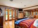 Bright main bedroom featuring hardwood floors, access to the outdoors, and an adjacent living area at 8022 N Ironwood Dr, Paradise Valley, AZ 85253