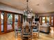 Elegant dining area with unique chairs, a decorative fireplace, and glass doors to the patio at 8022 N Ironwood Dr, Paradise Valley, AZ 85253