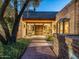 Inviting entryway with brick walls, hardwood floors, and a charming wooden door at 8022 N Ironwood Dr, Paradise Valley, AZ 85253