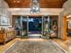 Elegant foyer with wood floors, a statement rug, and views of the backyard through glass doors at 8022 N Ironwood Dr, Paradise Valley, AZ 85253
