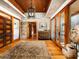 Stylish hallway with hardwood floors, brick walls, and a unique chandelier at 8022 N Ironwood Dr, Paradise Valley, AZ 85253