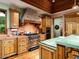 Charming kitchen featuring wood cabinets, stainless steel appliances, and a unique brick range hood at 8022 N Ironwood Dr, Paradise Valley, AZ 85253