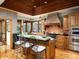 Charming kitchen with custom wood cabinetry, stainless steel appliances, and a brick range hood at 8022 N Ironwood Dr, Paradise Valley, AZ 85253