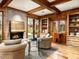 Inviting living area with a fireplace, built-in shelving, and French doors leading to the backyard at 8022 N Ironwood Dr, Paradise Valley, AZ 85253