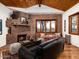 Cozy living room featuring a brick fireplace, built-in seating, and hardwood floors at 8022 N Ironwood Dr, Paradise Valley, AZ 85253