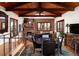 Upstairs living area with exposed beam ceiling, fireplace, and adjacent dining space at 8022 N Ironwood Dr, Paradise Valley, AZ 85253