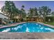Inviting swimming pool with brick coping, surrounded by lounge chairs, lush greenery, and a covered patio at 8022 N Ironwood Dr, Paradise Valley, AZ 85253