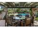 Relaxing poolside patio with comfortable seating, a large round table, and a view of the sparkling pool at 8022 N Ironwood Dr, Paradise Valley, AZ 85253
